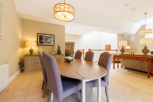 a dining room with a wooden table and chairs at Luxury 4 bedroom Lodge Mount Juliet Estate Thomastown Kilkenny in Oldtown
