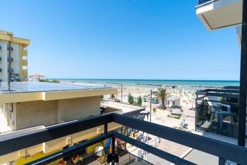 a balcony with a view of the beach at Hotel Milanese in Rimini