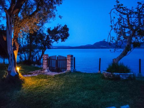 a view of a lake at night with a fence at Villa Spitaki in Nikiana
