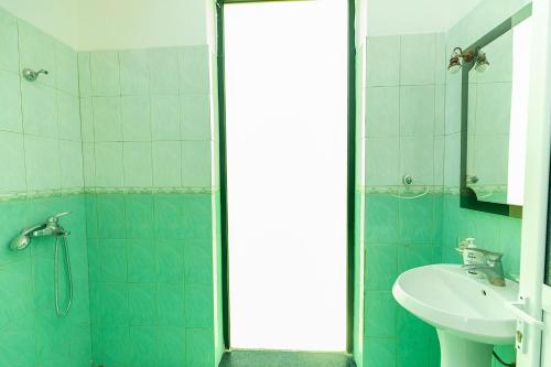 a bathroom with a sink and a shower at Hotel Dini in Vlorë