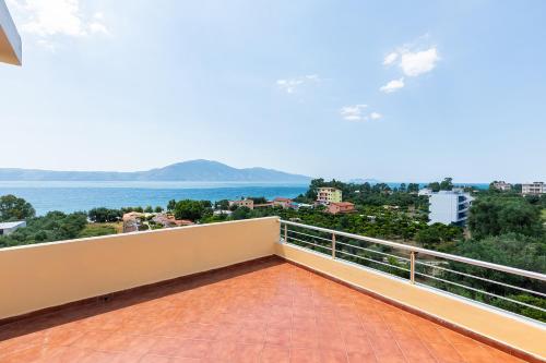a balcony with a view of the ocean at Hotel Dini in Vlorë