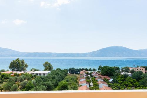 a view of a town and the ocean at Hotel Dini in Vlorë
