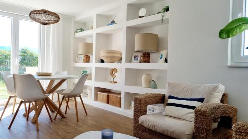 a living room with a table and chairs at Salt & Stone Villa in Pag