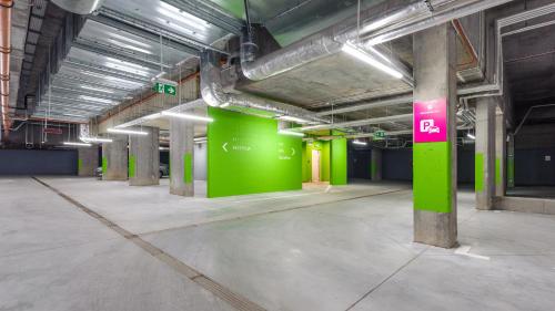 an empty parking garage with a green wall at Jantaris, Sun & Snow in Mielno