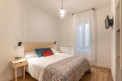 a bedroom with a large bed and a window at Casco Viejo: El Corazón de las Siete Calles in Bilbao