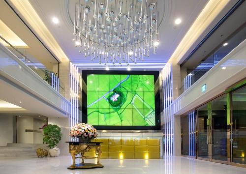 a large television in a lobby with a large window at Hù House - Taipei in Taipei