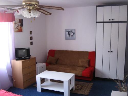 a living room with a couch and a table at Wisteria in Tivat
