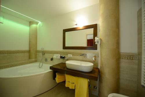 a bathroom with a sink and a toilet and a tub at Hotel Sole in Passo del Tonale