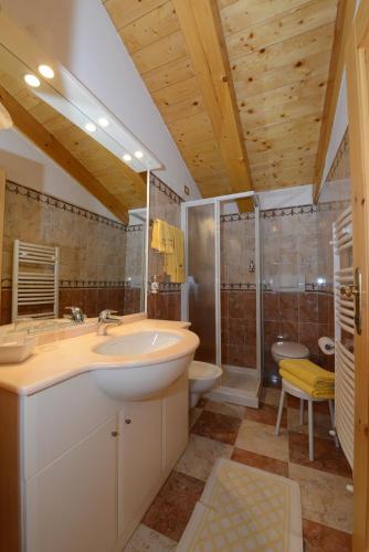 a bathroom with a sink and a toilet and a shower at Hotel Sole in Passo del Tonale