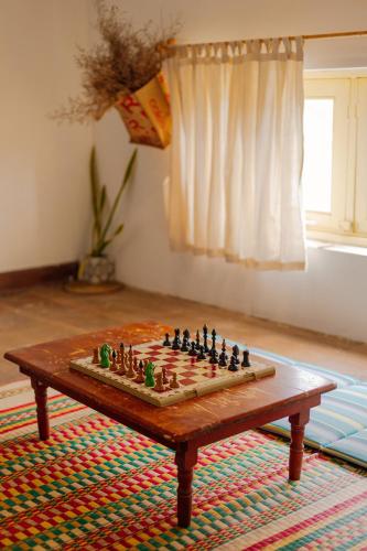 a chess board on a coffee table on a rug at Homestay in Tay Ninh in Tây Ninh