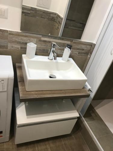 a bathroom with a white sink and a mirror at CASA ARUCI in Avola