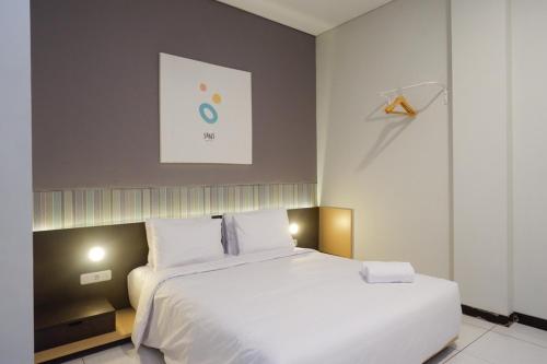 Katil atau katil-katil dalam bilik di Sans Hotel Good Wish Semarang