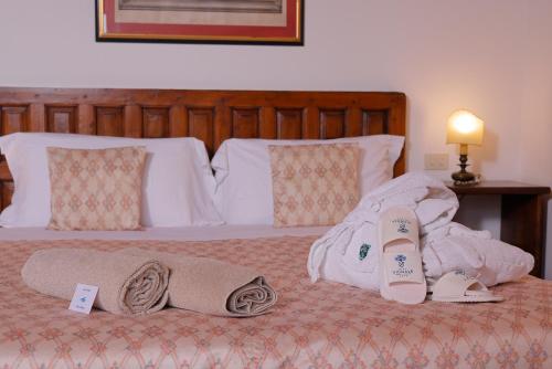 a bedroom with a bed with towels on it at Relais Vignale & Spa in Radda in Chianti