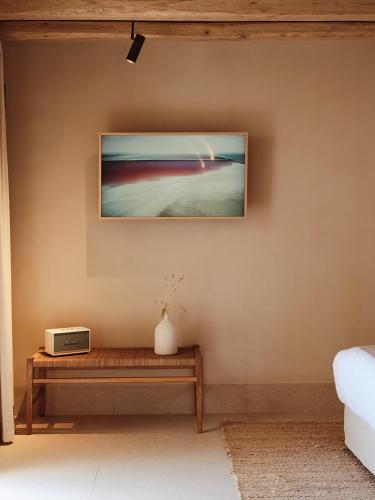 a room with a table and a picture on the wall at NOS Hotel & Villas in Sifnos
