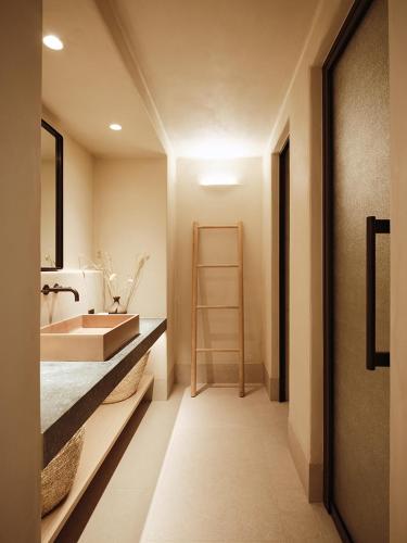 a bathroom with a sink and a mirror at NOS Hotel & Villas in Sifnos