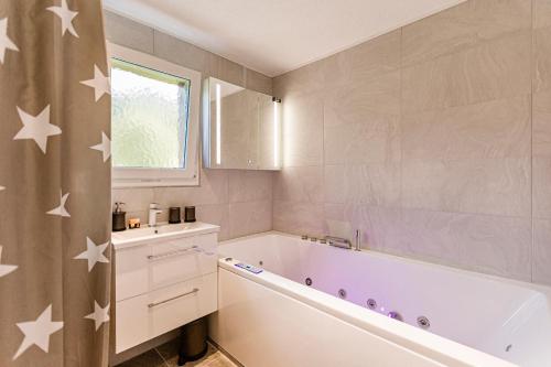 a bathroom with a tub and stars on the wall at Ferienwohnung Ägerisee in Oberägeri