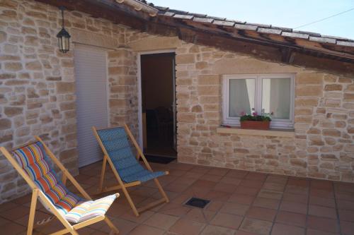 two chairs on a patio in front of a house at Chateau Le Livey in Saint-Pierre-dʼAurillac