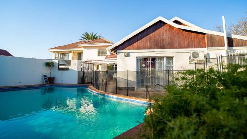 a swimming pool in front of a house at 17 on 13th in Edenvale