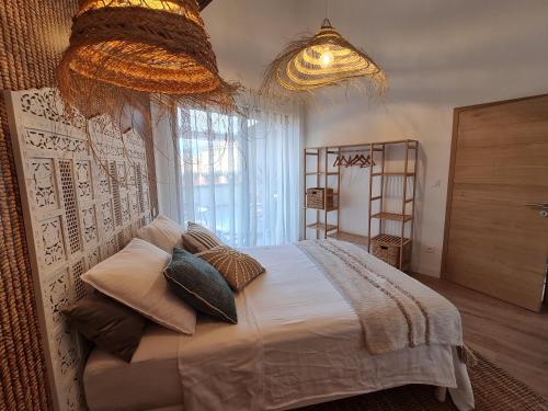 a bedroom with a large bed and a large window at Gite cosy dans une demeure de charme - Romane in Thuir