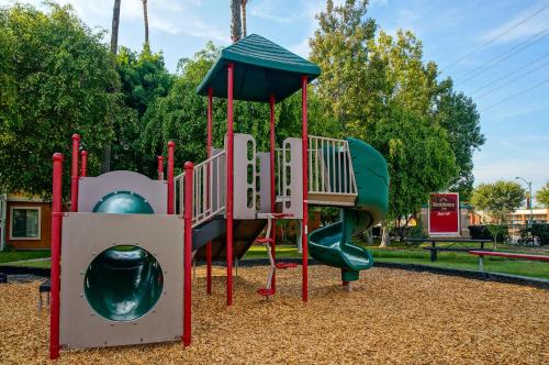 a playground with a slide in a park at Clementine Hotel & Suites Anaheim in Anaheim