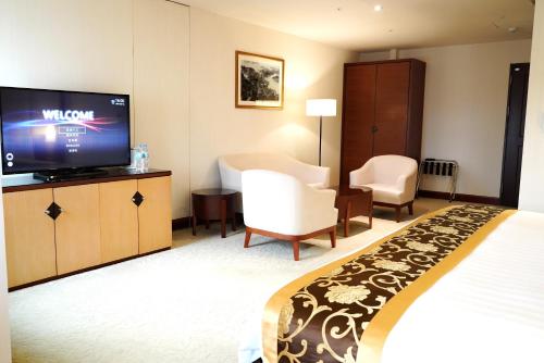 a hotel room with a bed and a flat screen tv at Hù House - Taipei in Taipei