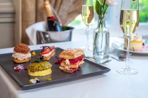a plate of food on a table with glasses of wine at Newpark Hotel in Kilkenny