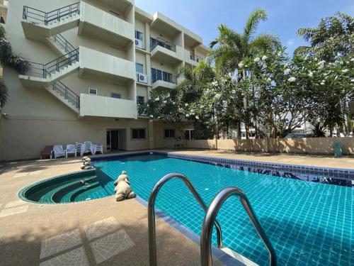 a swimming pool in front of a building at C.A.P Mansion in Phuket