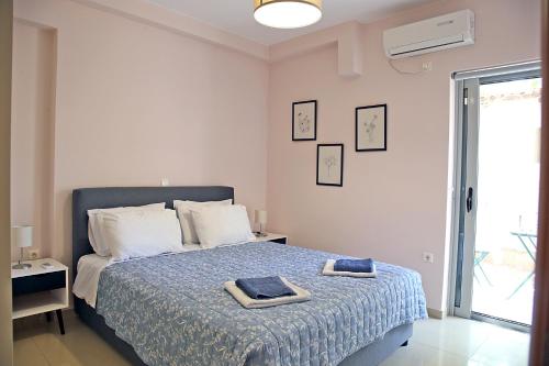 a bedroom with a bed with two towels on it at 2 Bedroom Apartment near the Athens Airport, Spata in Spáta