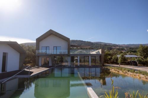 a house with a swimming pool in front of it at Quinta da Sra Marocas in Covilhã