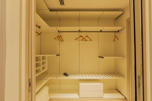 a walk in closet with shelves and hangers at Heliconia Park Port Harcourt Hotel and Suites in Port Harcourt