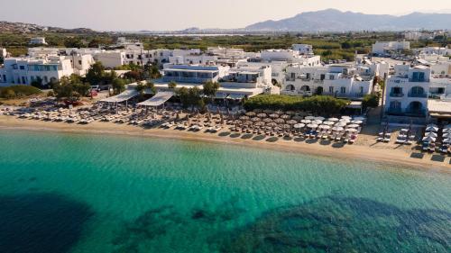 an aerial view of a beach with chairs and buildings at Castello studios in Agia Anna Naxos