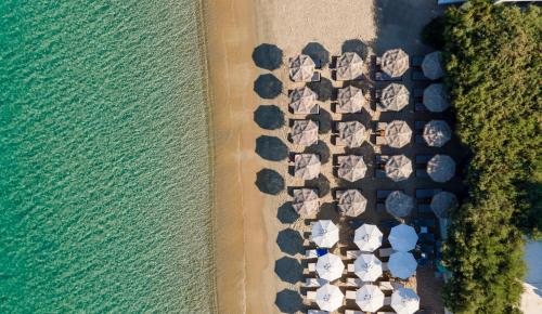 an aerial view of a beach with umbrellas at Castello studios in Agia Anna Naxos