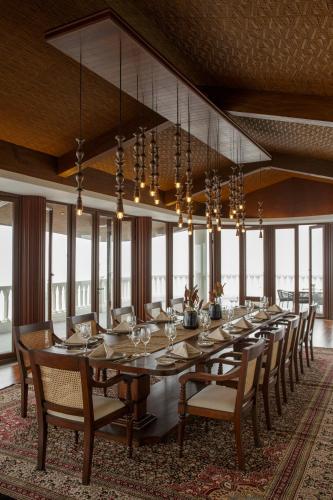 a large dining room with a long table and chairs at Plataran Bromo in Bromo