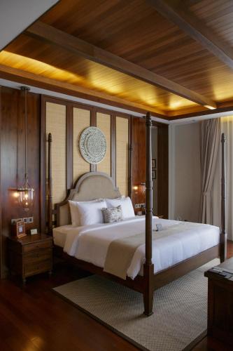 a bedroom with a large bed with a wooden ceiling at Plataran Bromo in Bromo