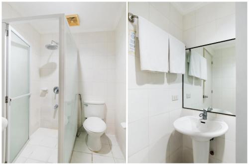 a white bathroom with a toilet and a sink at Hotel Euroasia By BLUEBOOKERS in Angeles