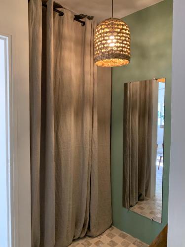 La salle de bains est pourvue d'un rideau de douche et d'un miroir. dans l'établissement Le Domaine de l'Aiguille Alpilles, Eygalières, Saint Rémy de Provence, à Orgon