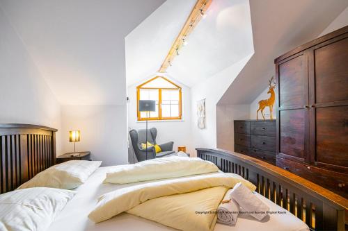 a bedroom with two beds and a dresser at Schönblick Mountain Resort & Spa - Das Original! in Rauris