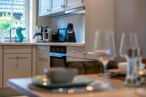 a kitchen with a table with glasses on it at Haus Sylter Inselglück in Tinnum
