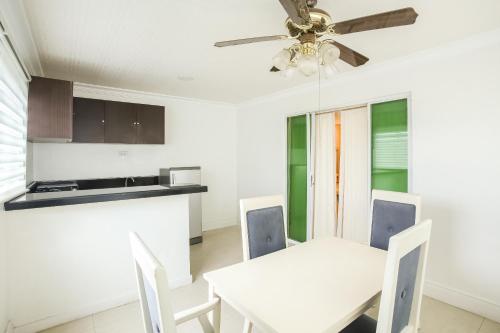 a dining room with a white table and a ceiling fan at Hotel Euroasia By BLUEBOOKERS in Angeles