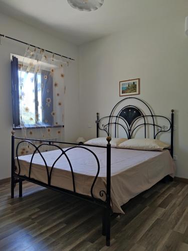 a bedroom with two beds and a window at Foresteria del Re in Montelupone