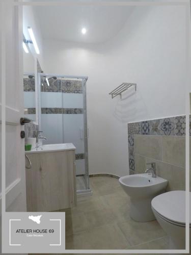 a bathroom with a toilet and a sink at Atelier House 69 in Trappeto
