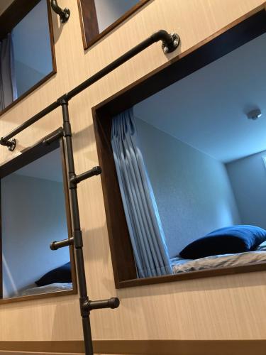 a room with two mirrors and a bed in it at 柏島ヴィレッジ in Otsuki