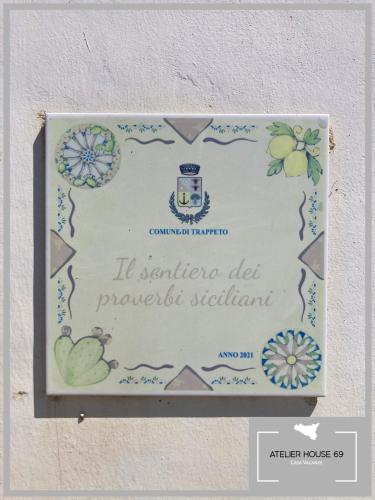a sign on a wall that reads la santander diet promise sodium at Atelier House 69 in Trappeto
