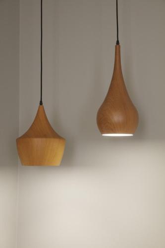 three wooden pendant lights hanging from a white wall at Logis Hôtel - Restaurant Maison Claude Darroze in Langon