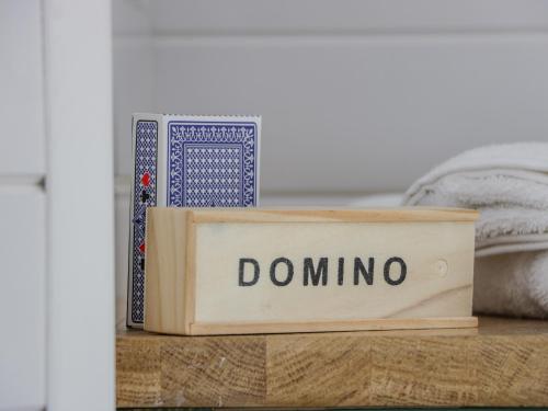 a wooden box with the word domino sitting on a table at Laird Lodge 3 in Lockerbie