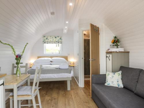 a bedroom with a bed and a couch in a room at Laird Lodge 3 in Lockerbie