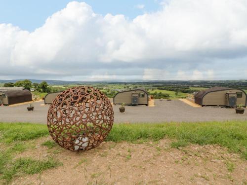 a sculpture of an egg sitting in the grass at Laird Lodge 3 in Lockerbie