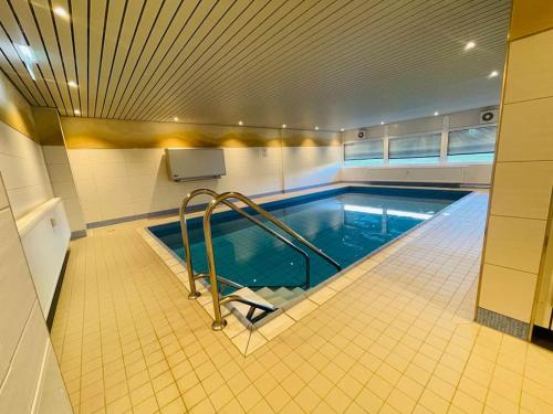 a swimming pool in a large room with at Apartment Diekblk mit Pool in Dahme