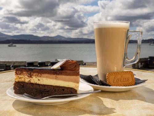 a piece of cake and a drink on a table at The Bulkeley Hotel in Beaumaris
