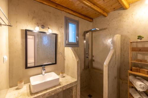 a bathroom with a sink and a shower at Aelia House Serifos in Serifos Chora